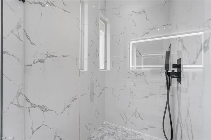 Bathroom featuring tiled shower