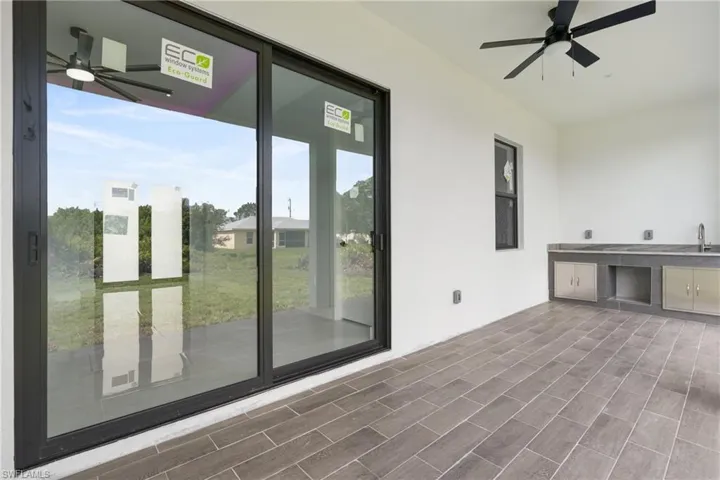 Unfurnished room featuring sink and ceiling fan