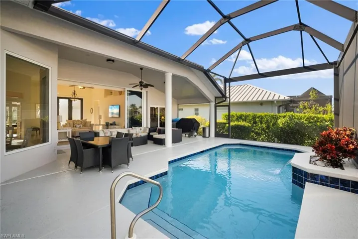 View of swimming pool with an outdoor hangout area, a patio, ceiling fan, and glass enclosure