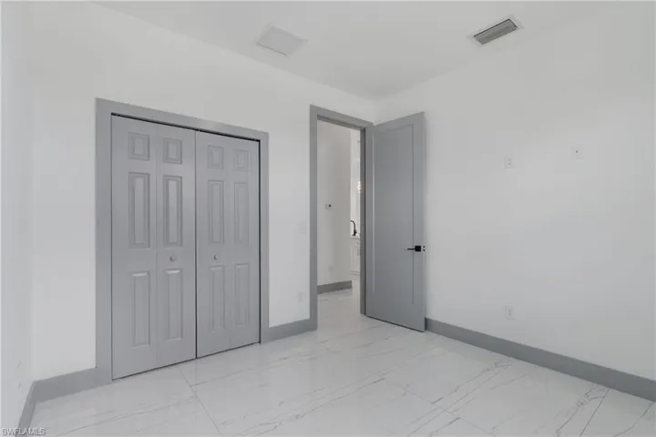 Unfurnished bedroom featuring a closet and light tile patterned floors