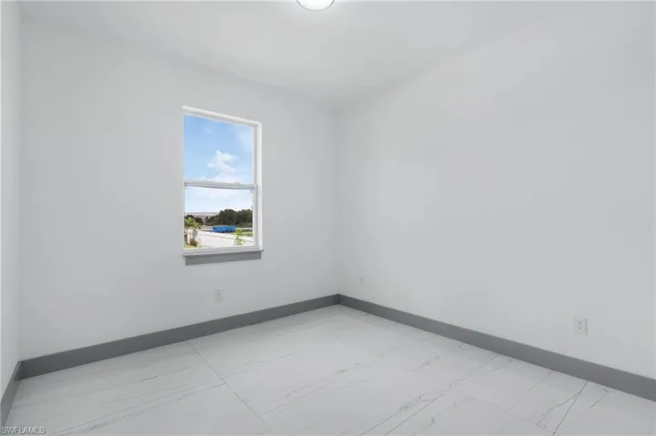 Unfurnished room featuring light tile patterned flooring