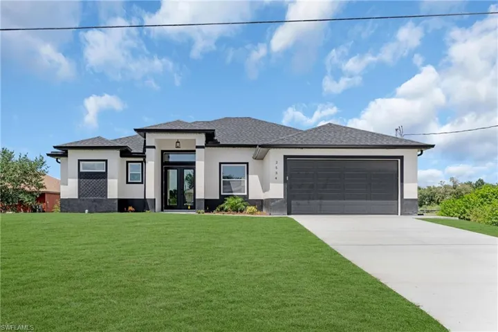 Prairie-style home with a garage and a front lawn