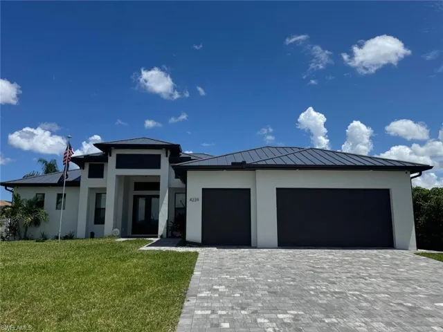 Prairie-style home with a standing seam roof, a metal roof, and stucco siding