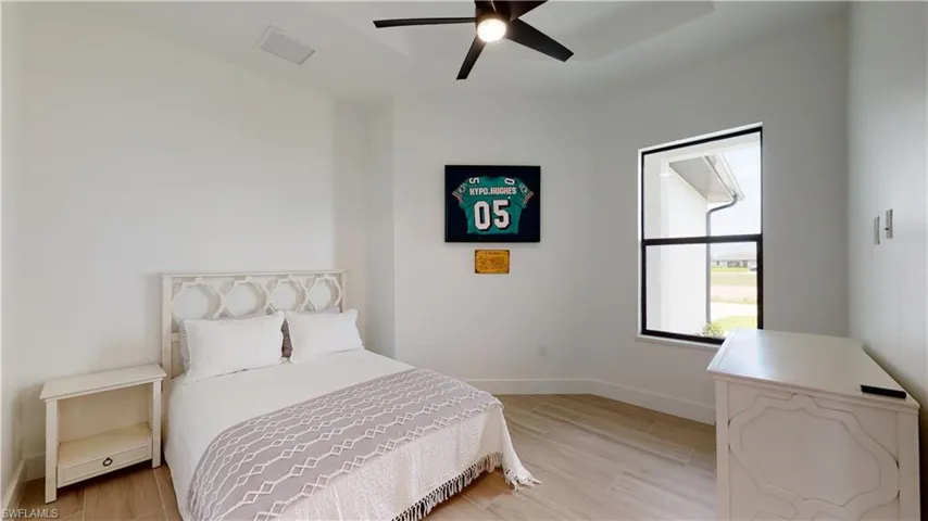 Bedroom with light wood-style flooring and ceiling fan