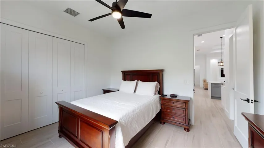 Bedroom with a closet, a ceiling fan, and wood finish floors