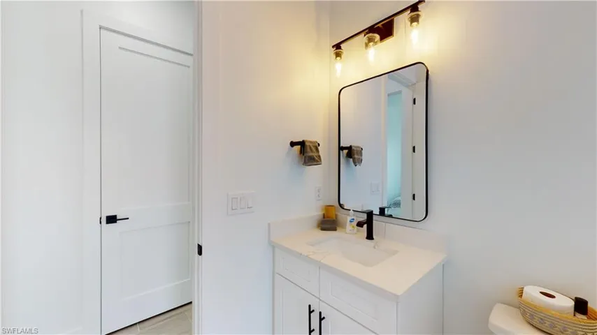 Bathroom featuring vanity and toilet