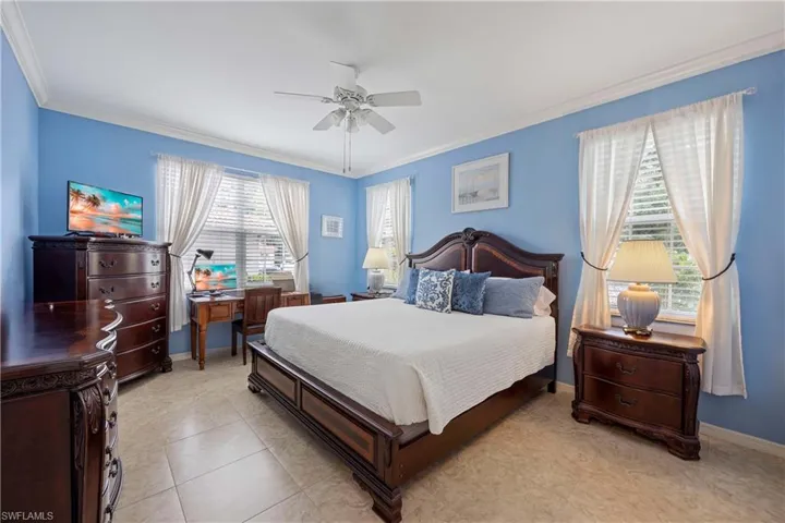 Master Bedroom with crown molding, ceiling fan, and baseboards