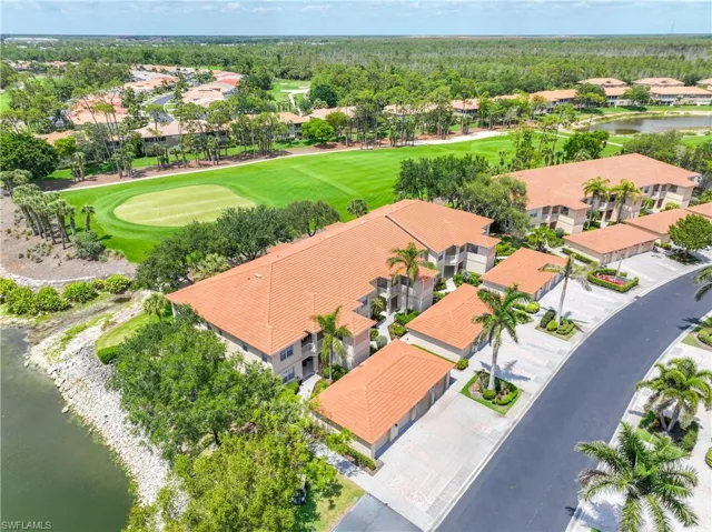 Aerial perspective of suburban area with a nearby body of water and a local golf course