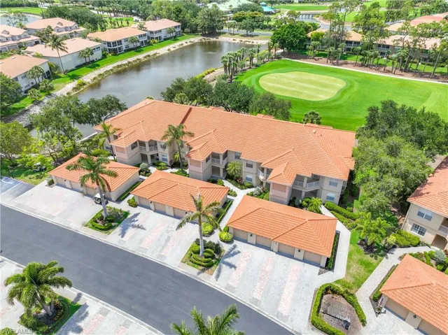Aerial view of residential area with a nearby body of water and a golf club