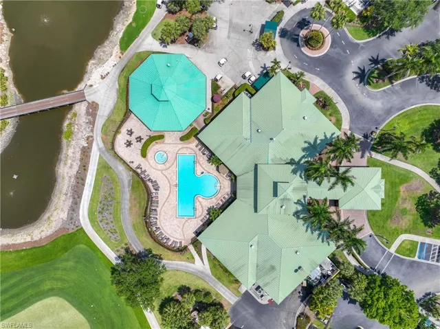 Aerial view of a pool and a nearby body of water
