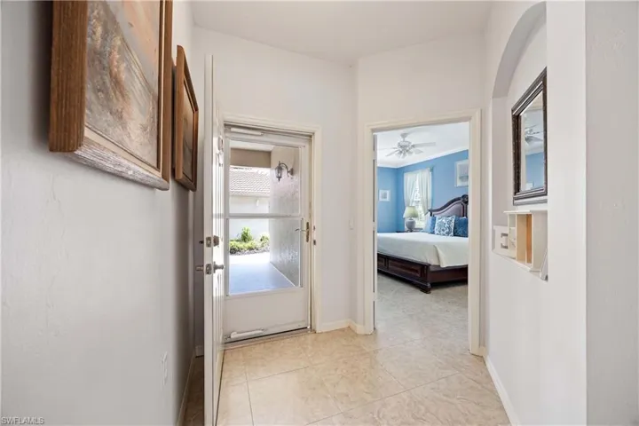Hall featuring baseboards and light tile patterned floors