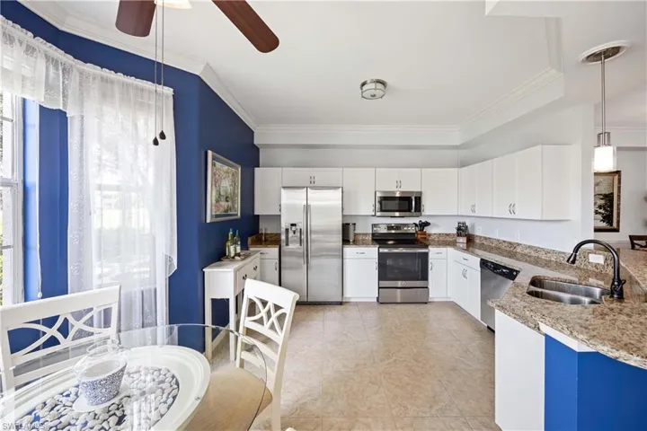 Living area with crown molding and a ceiling fan