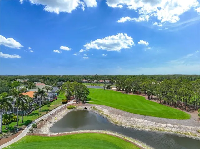 Drone / aerial view of a local golf course and a nearby body of water