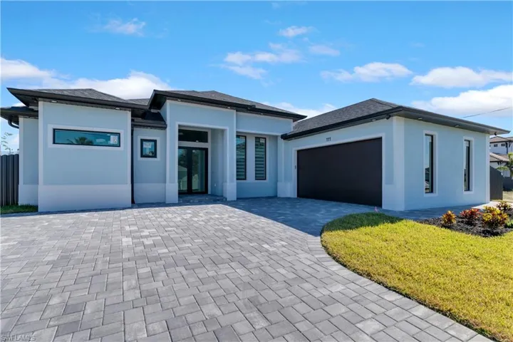 View of front facade featuring a garage