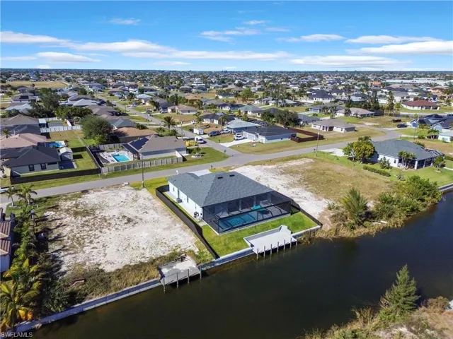Birds eye view of property with a water view