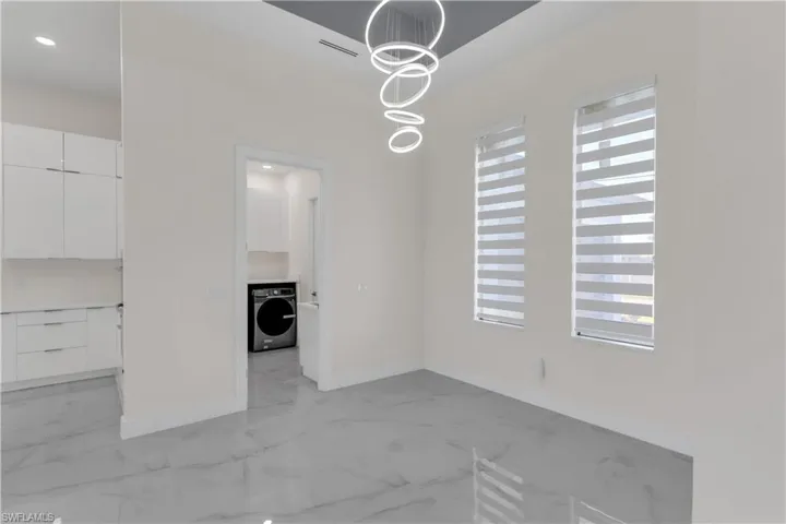 Unfurnished dining area with washer / clothes dryer and plenty of natural light