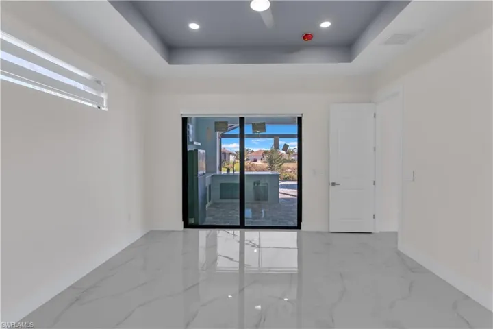 Empty room featuring a raised ceiling