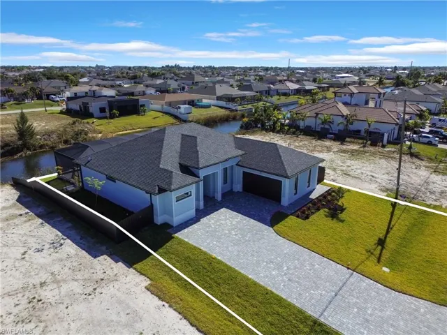 Birds eye view of property with a water view