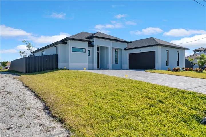 View of front of house featuring a front yard and a garage