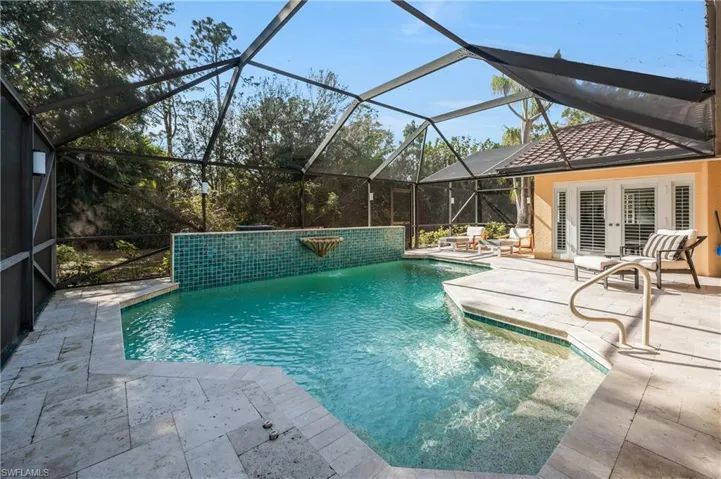 View of swimming pool featuring a lanai, a patio, pool water feature, and french doors