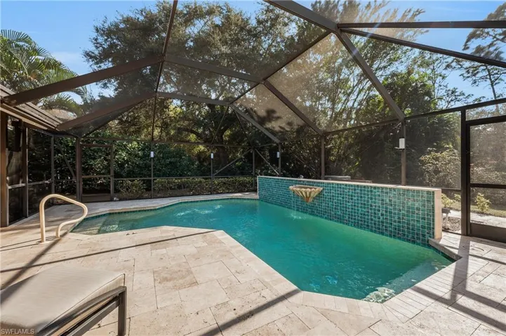 View of pool featuring pool water feature, a lanai, and a patio