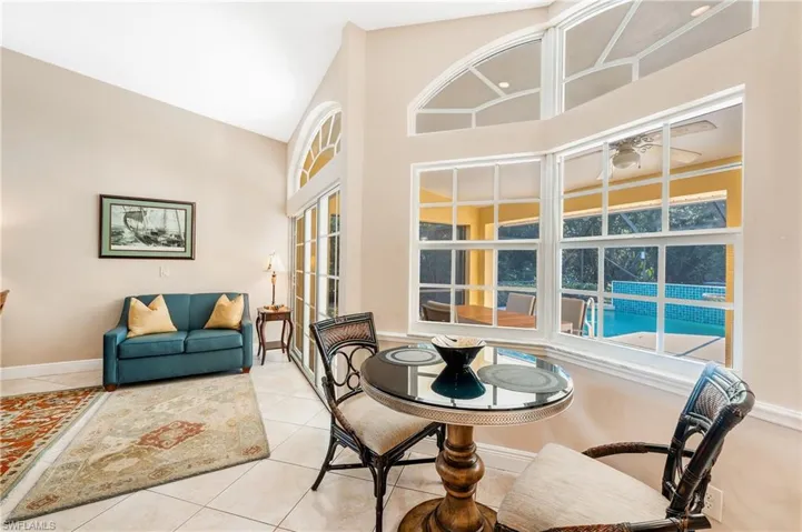 Tiled dining area with a towering ceiling and ceiling fan