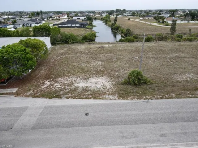 Birds eye view of property with paved road