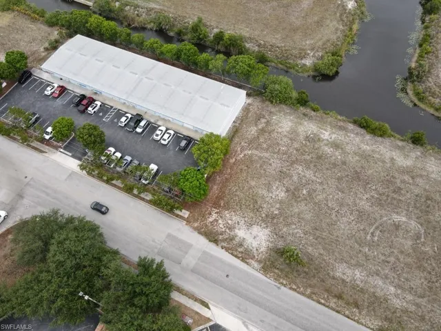 Aerial view featuring neighboring plaza to west and parcel