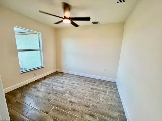 Den that easily be 4th bedroom with wood plank porcelain tile floors.