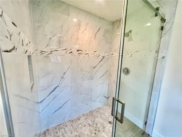 Primary bathroom with frameless glass shower door.
