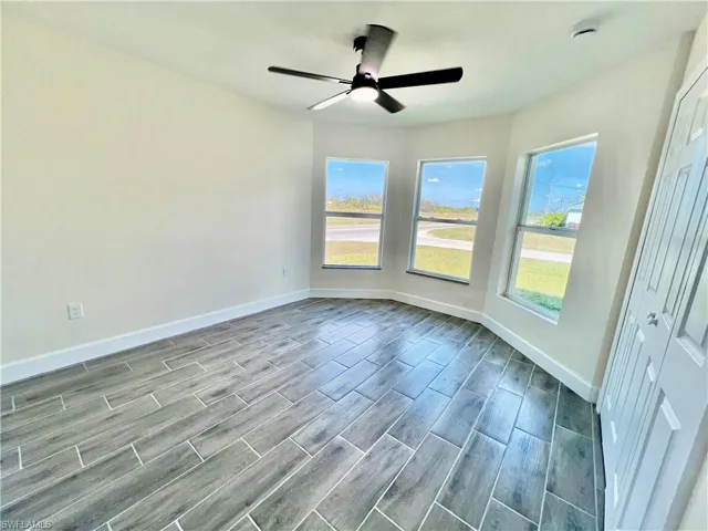 Guest bedroom featuring ceiling fan and plenty of natural light