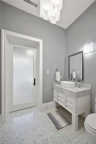 Half bath featuring vanity and toilet