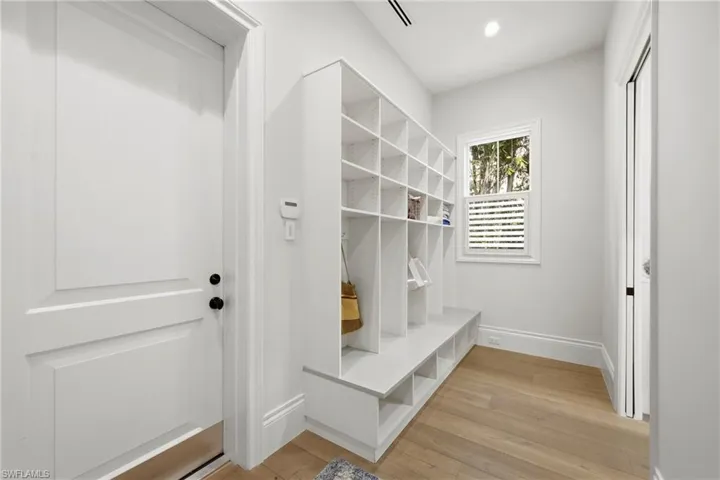 Mudroom with light wood-type flooring and recessed lighting