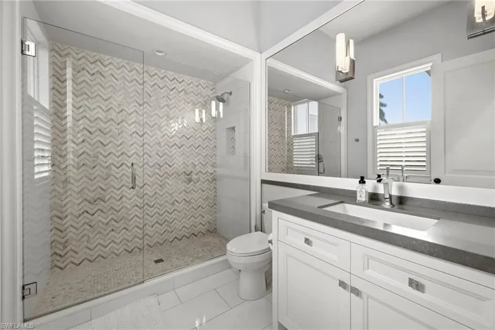 Bathroom with a stall shower, vanity, and light tile patterned floors