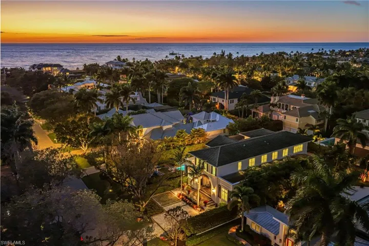 Aerial view at dusk of a water view and a residential view