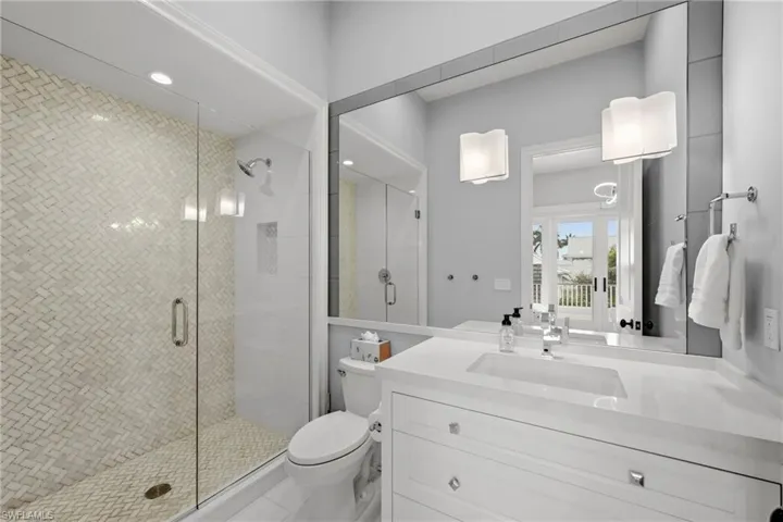 Bathroom featuring vanity, a shower stall, and recessed lighting