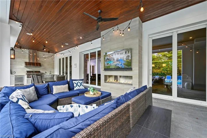 View of patio / terrace featuring an outdoor kitchen and area to lounge and ceiling fan