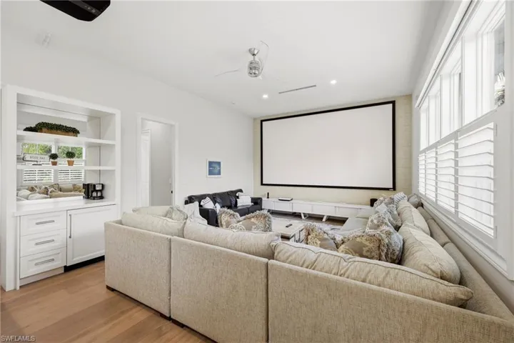 Cinema room with recessed lighting, light wood-type flooring, and a ceiling fan