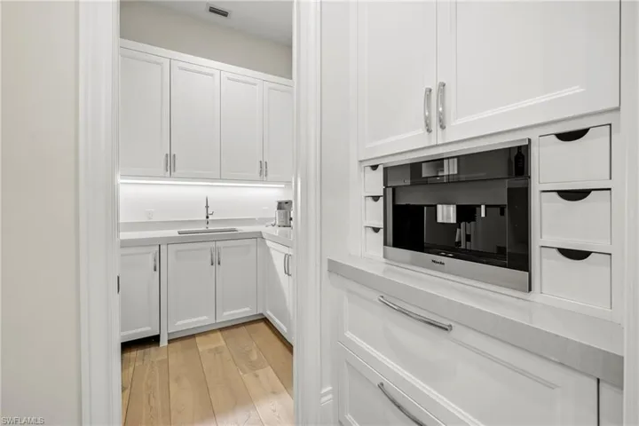Kitchen featuring expresso coffee maker.