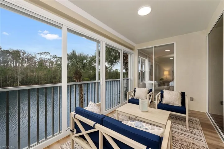 Sunroom / solarium with a water view