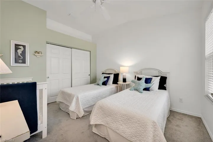 Bedroom featuring lofted ceiling, carpet flooring, a closet, and ceiling fan