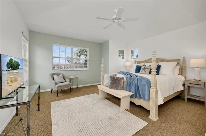 Carpeted bedroom with ceiling fan