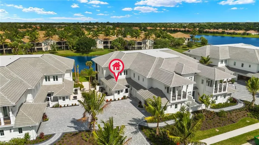 Birds eye view of property with a water view