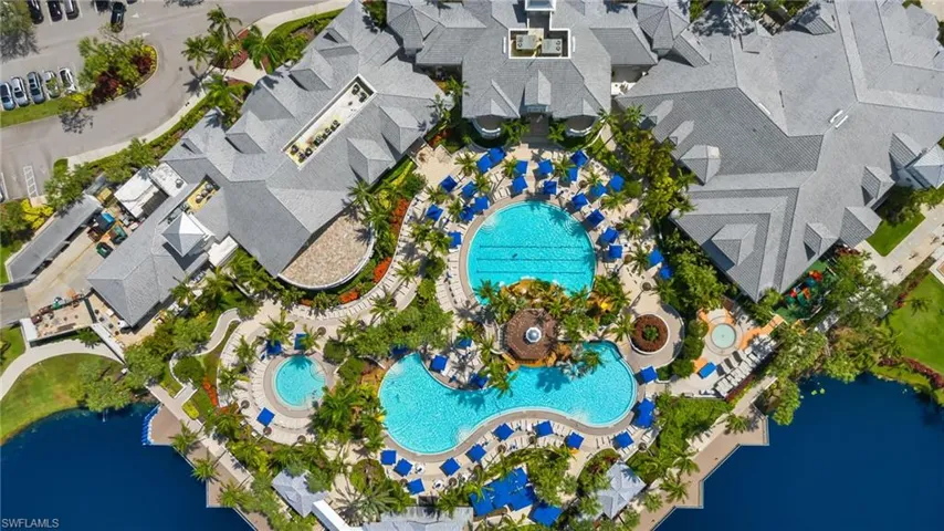 Drone / aerial view of Fiddler's Creek community pools & restaurant with a water view