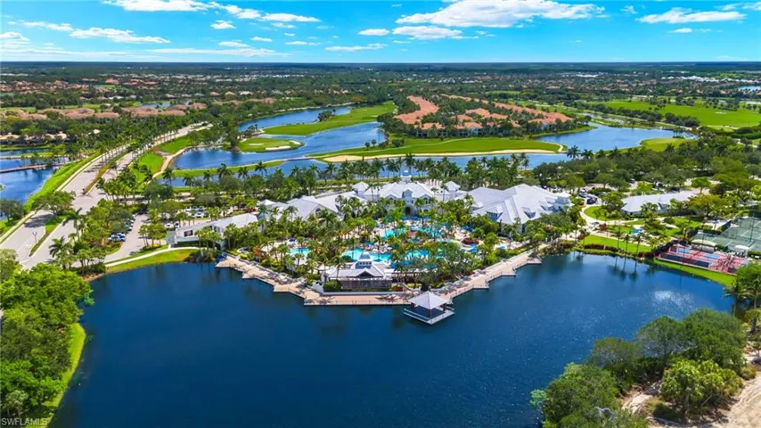 Birds eye view of Fiddler's Creek Community Pool with a water view. This area consists of pools, kiddie pools, restaurants and loads of seating to meet your neighbors or just sit back and soak in the beautiful weather