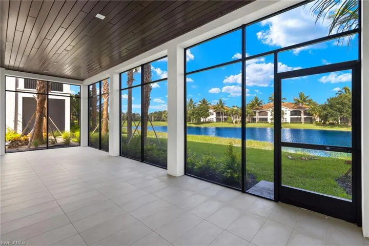Unfurnished view of lanai featuring a wealth of natural light and a water view