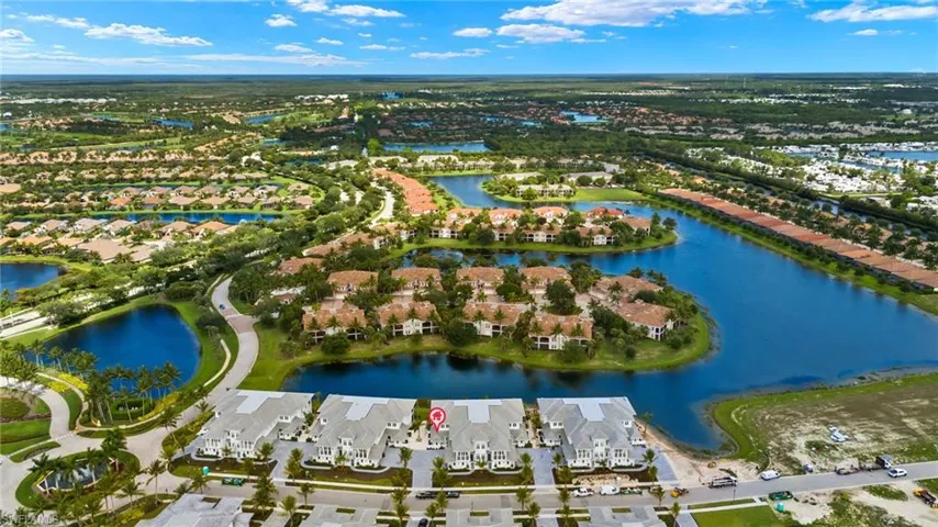 Birds eye view of property with a water view