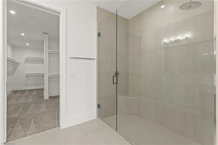 Bathroom with tile floors and a shower with shower door