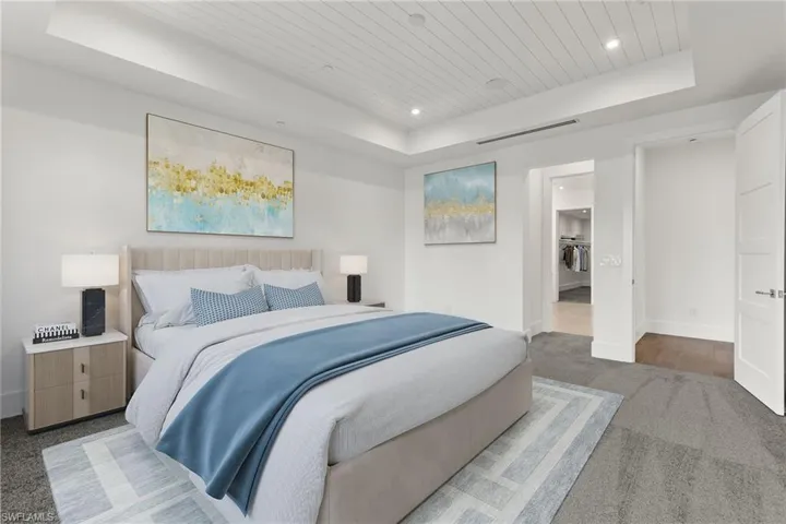 Master Bedroom Suite with carpet flooring, a raised ceiling and leading to an expansive master bath and walk in closet...Must see to actually believe!