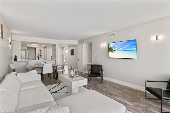 Generously sized living room with tranquil lake views, thoughtfully designed to host gatherings with ease and grace.